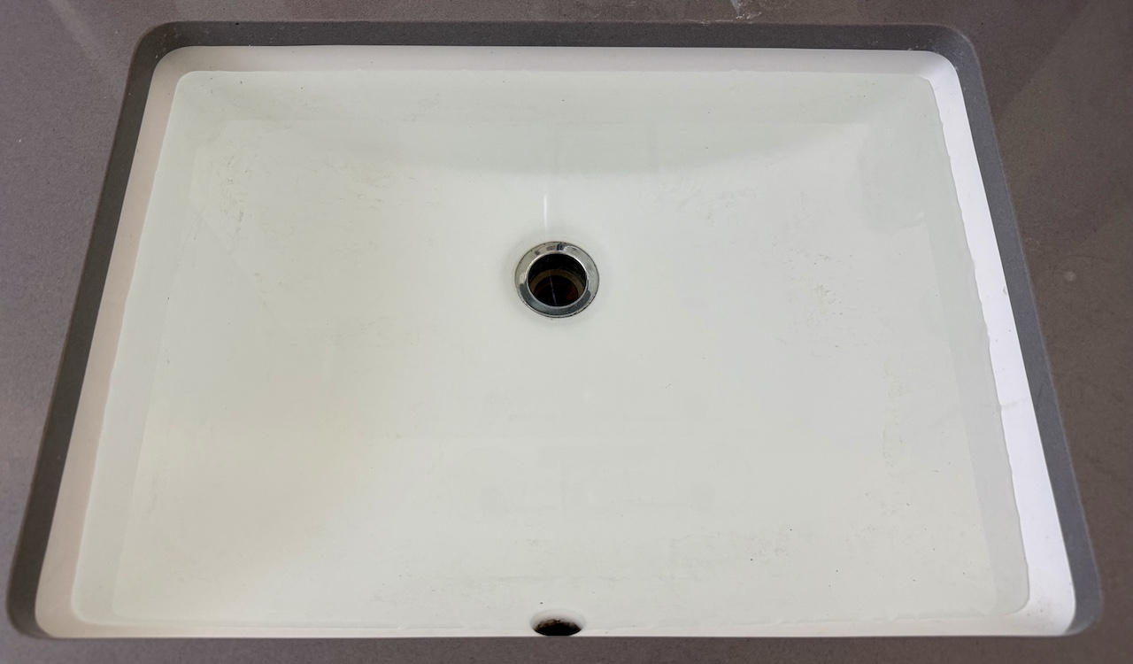 House sink filled with water from clogged A/C condensate drain line